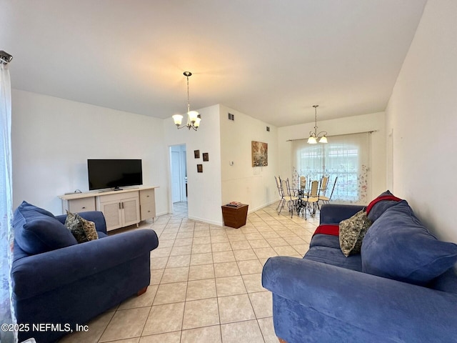 living room with an inviting chandelier and light tile patterned flooring