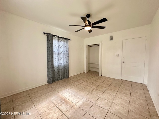 unfurnished bedroom with light tile patterned floors and ceiling fan