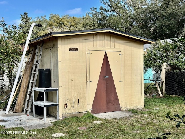 view of outbuilding with a lawn