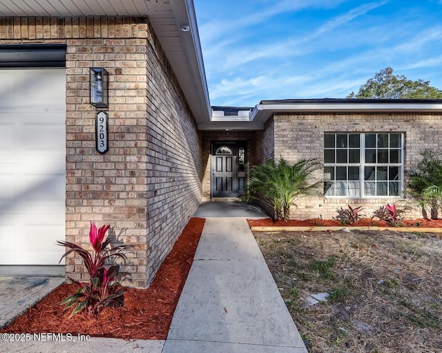 view of exterior entry with a garage