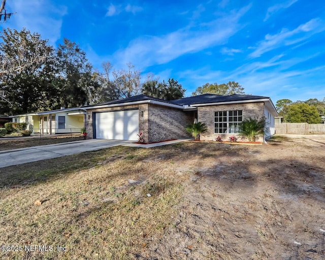 single story home featuring a garage and a front yard