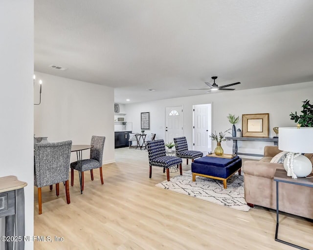 living room featuring ceiling fan and light wood-type flooring