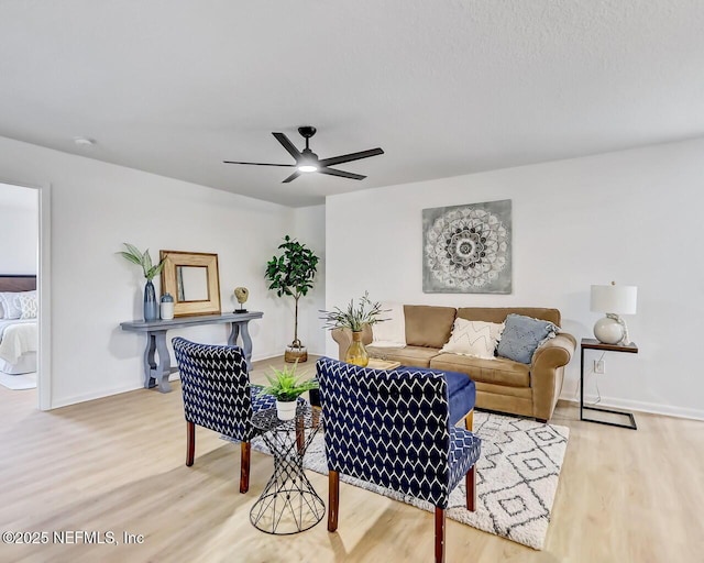 living room with hardwood / wood-style flooring and ceiling fan