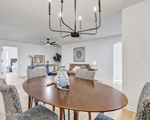 dining room with ceiling fan and light hardwood / wood-style flooring