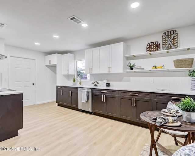 kitchen with dishwasher, sink, white cabinets, dark brown cabinetry, and light wood-type flooring