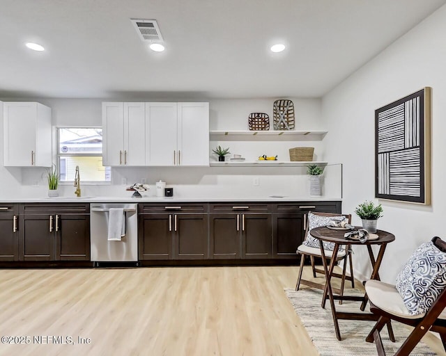 kitchen featuring dishwasher, white cabinets, dark brown cabinetry, and light hardwood / wood-style flooring