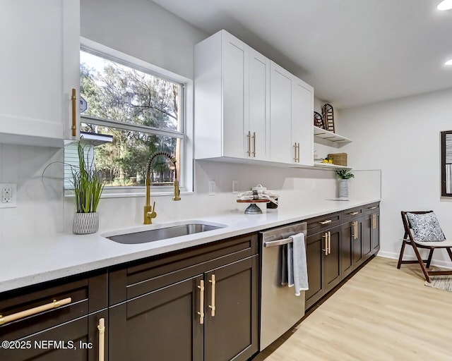 kitchen with white cabinetry, dishwasher, sink, light hardwood / wood-style floors, and dark brown cabinets