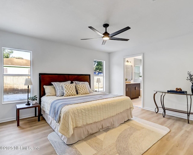 bedroom featuring ceiling fan, ensuite bathroom, and hardwood / wood-style floors