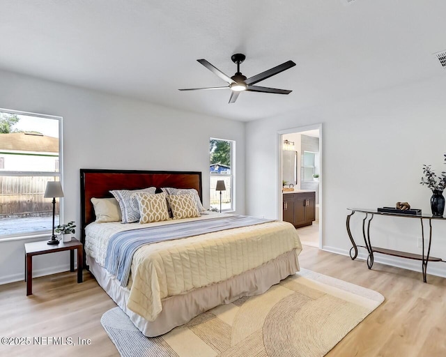 bedroom featuring ensuite bathroom, ceiling fan, and light hardwood / wood-style floors