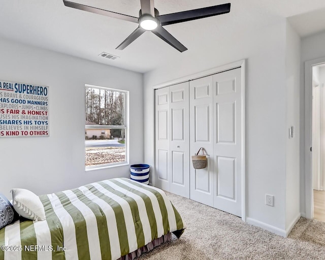 bedroom featuring ceiling fan, light colored carpet, and a closet