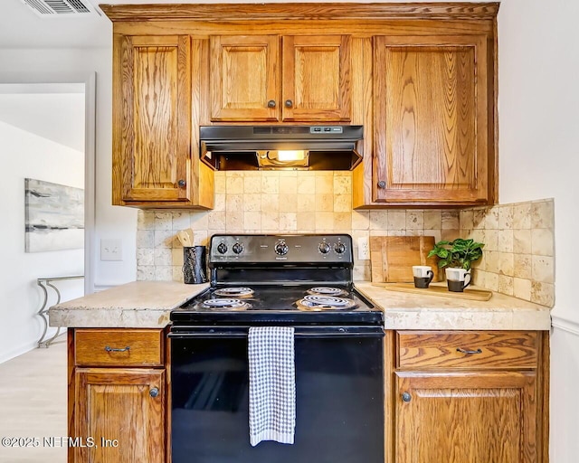 kitchen with tasteful backsplash and black / electric stove