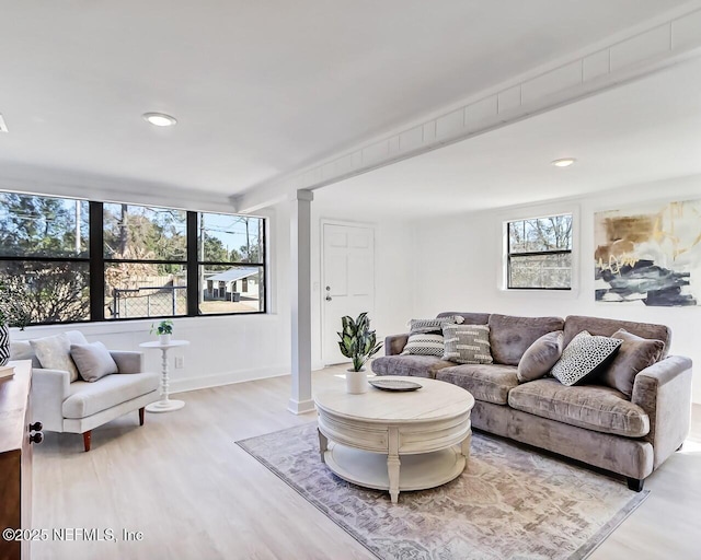 living room featuring hardwood / wood-style floors and decorative columns