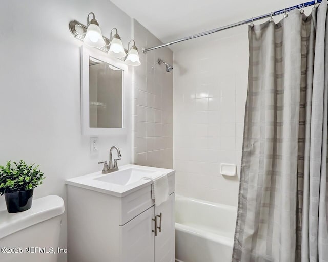 full bathroom featuring shower / bath combo, vanity, and toilet