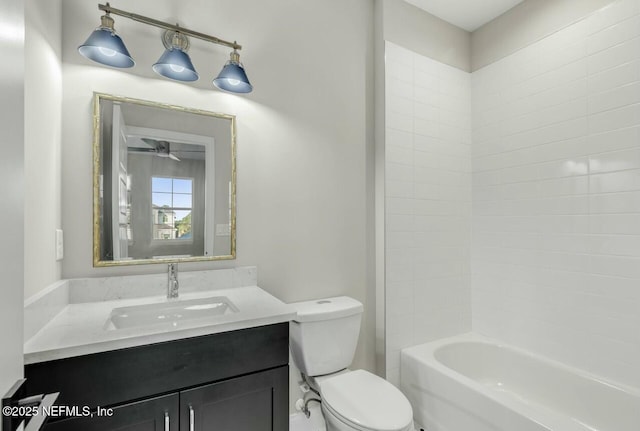 full bathroom featuring vanity, tiled shower / bath combo, and toilet