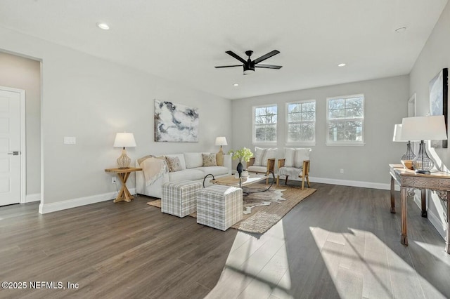 living room with dark hardwood / wood-style flooring and ceiling fan