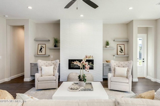 living room featuring hardwood / wood-style floors and ceiling fan