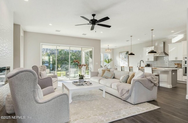 living room featuring sink, dark hardwood / wood-style floors, and ceiling fan