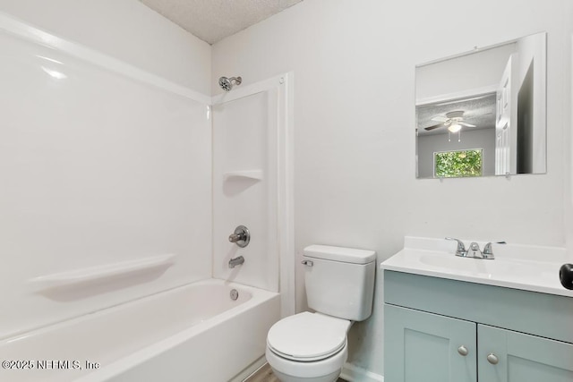 full bathroom featuring vanity, a textured ceiling,  shower combination, and toilet