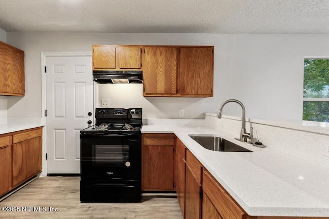 kitchen with sink, light hardwood / wood-style floors, black electric range, and a textured ceiling