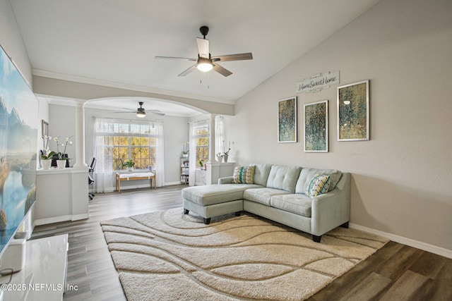 living room with hardwood / wood-style flooring, ceiling fan, vaulted ceiling, and ornate columns