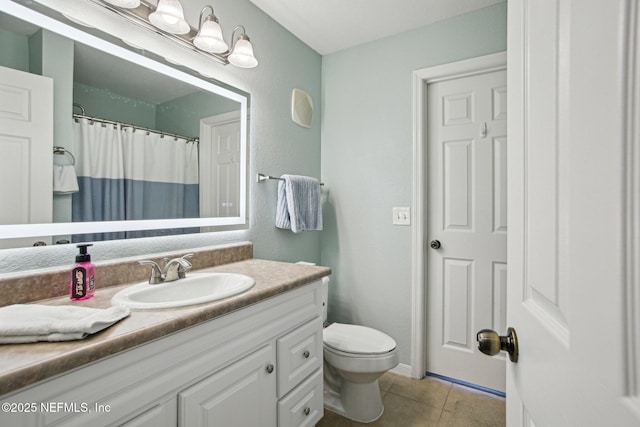 bathroom featuring vanity, tile patterned floors, toilet, and walk in shower