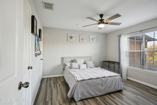 bedroom with dark wood-type flooring and ceiling fan