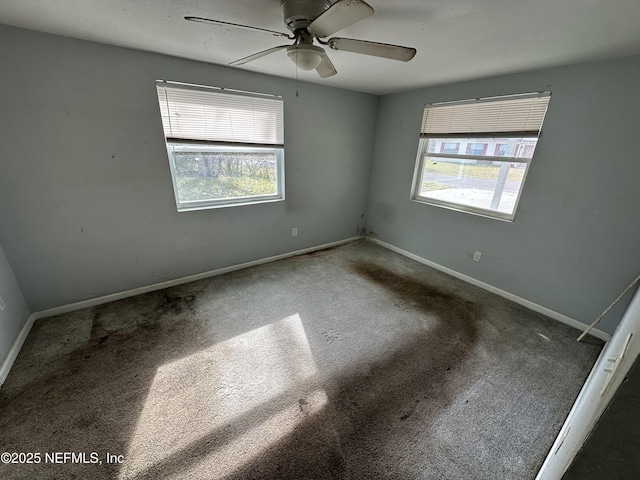 unfurnished room featuring ceiling fan and carpet flooring