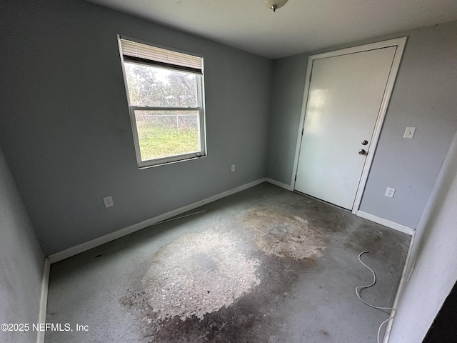 unfurnished room with concrete floors