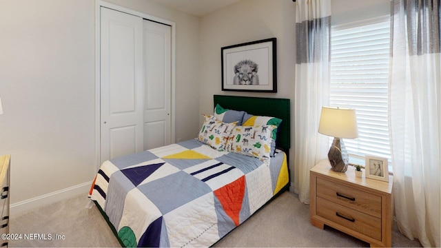 carpeted bedroom with a closet