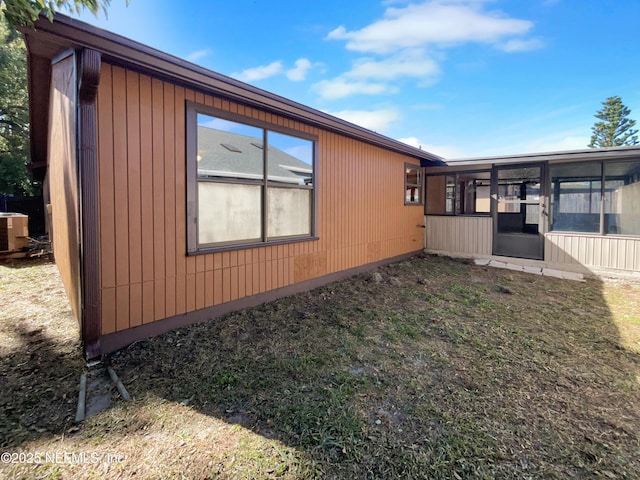 view of side of home with a sunroom and central air condition unit