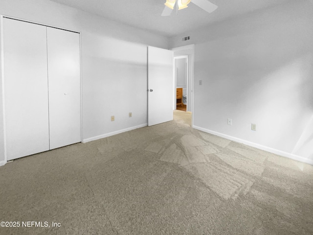 unfurnished bedroom featuring ceiling fan and carpet flooring