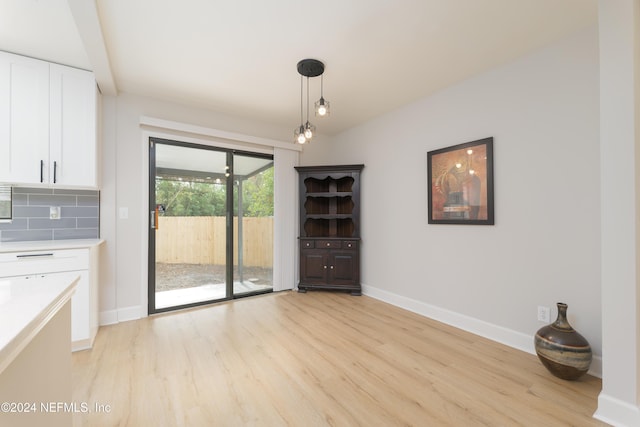 unfurnished dining area with light hardwood / wood-style flooring