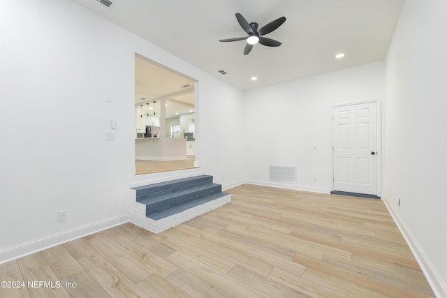 unfurnished living room featuring light hardwood / wood-style floors and ceiling fan