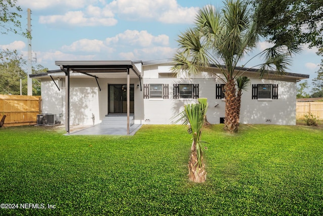 rear view of house featuring a yard, a patio, and central air condition unit