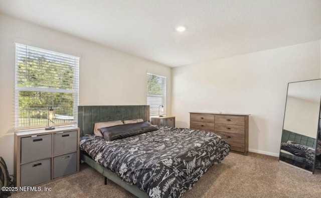 carpeted bedroom with baseboards