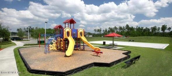 community jungle gym featuring a lawn