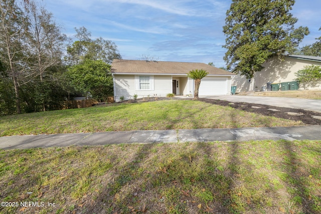 single story home featuring concrete driveway, an attached garage, and a front yard