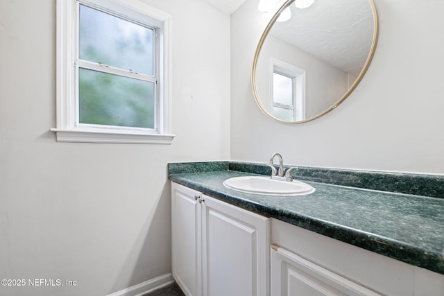 bathroom with vanity and baseboards