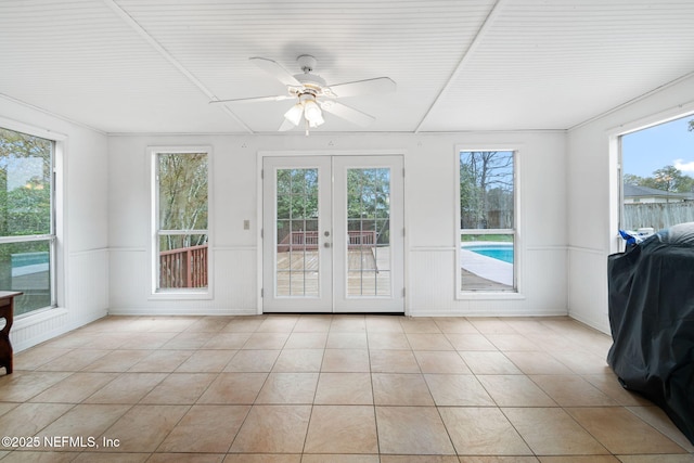 unfurnished sunroom with french doors and a ceiling fan