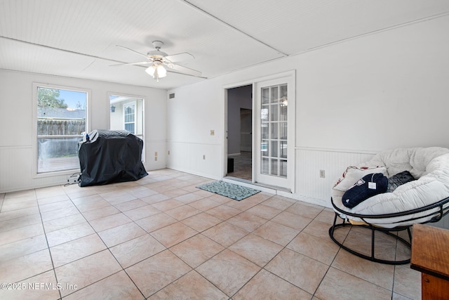 sunroom / solarium featuring a ceiling fan