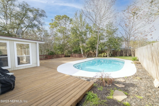 view of swimming pool with a fenced backyard, a fenced in pool, and a wooden deck