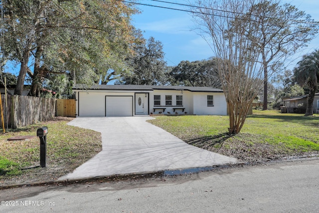 ranch-style house featuring a garage and a front yard