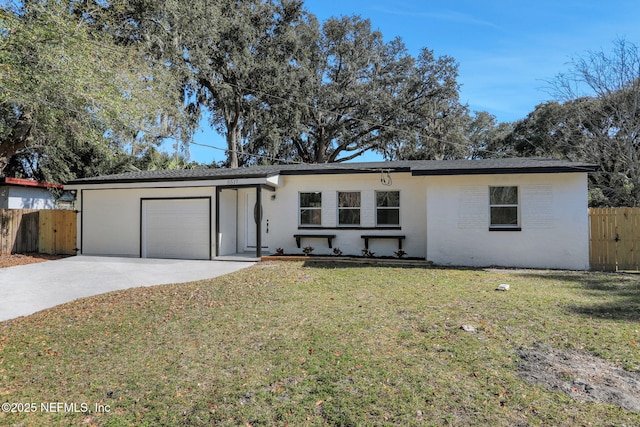 ranch-style house with a garage and a front lawn