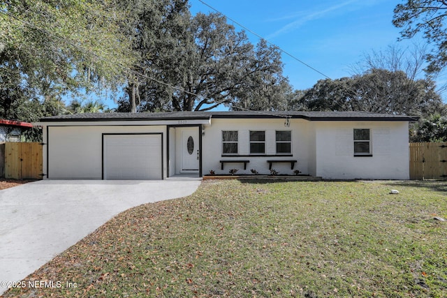 ranch-style house with a garage and a front lawn