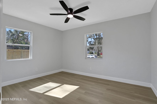 spare room featuring ceiling fan, plenty of natural light, and hardwood / wood-style floors