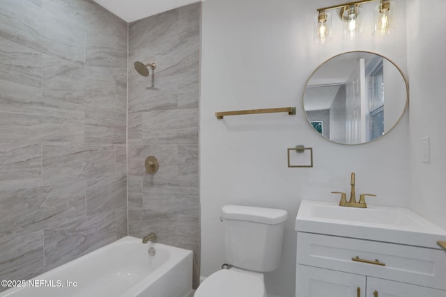 full bathroom with tiled shower / bath, vanity, and toilet