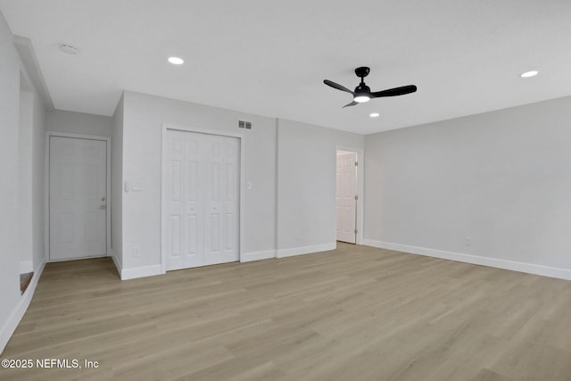 unfurnished bedroom with light hardwood / wood-style flooring, a closet, and ceiling fan