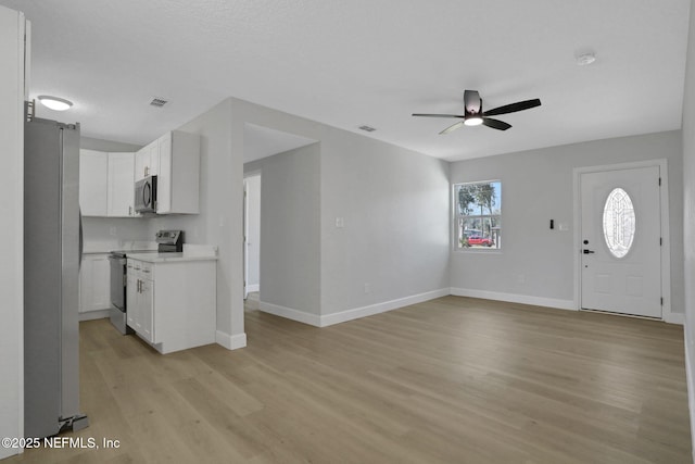 interior space with light hardwood / wood-style floors and ceiling fan