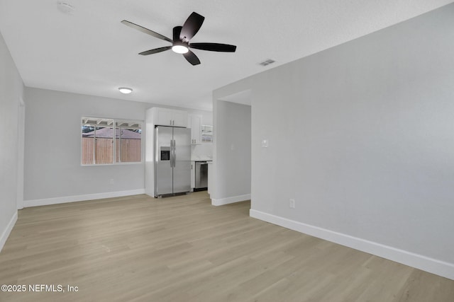 unfurnished living room with ceiling fan and light wood-type flooring