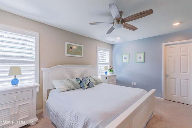 bedroom featuring light carpet and ceiling fan